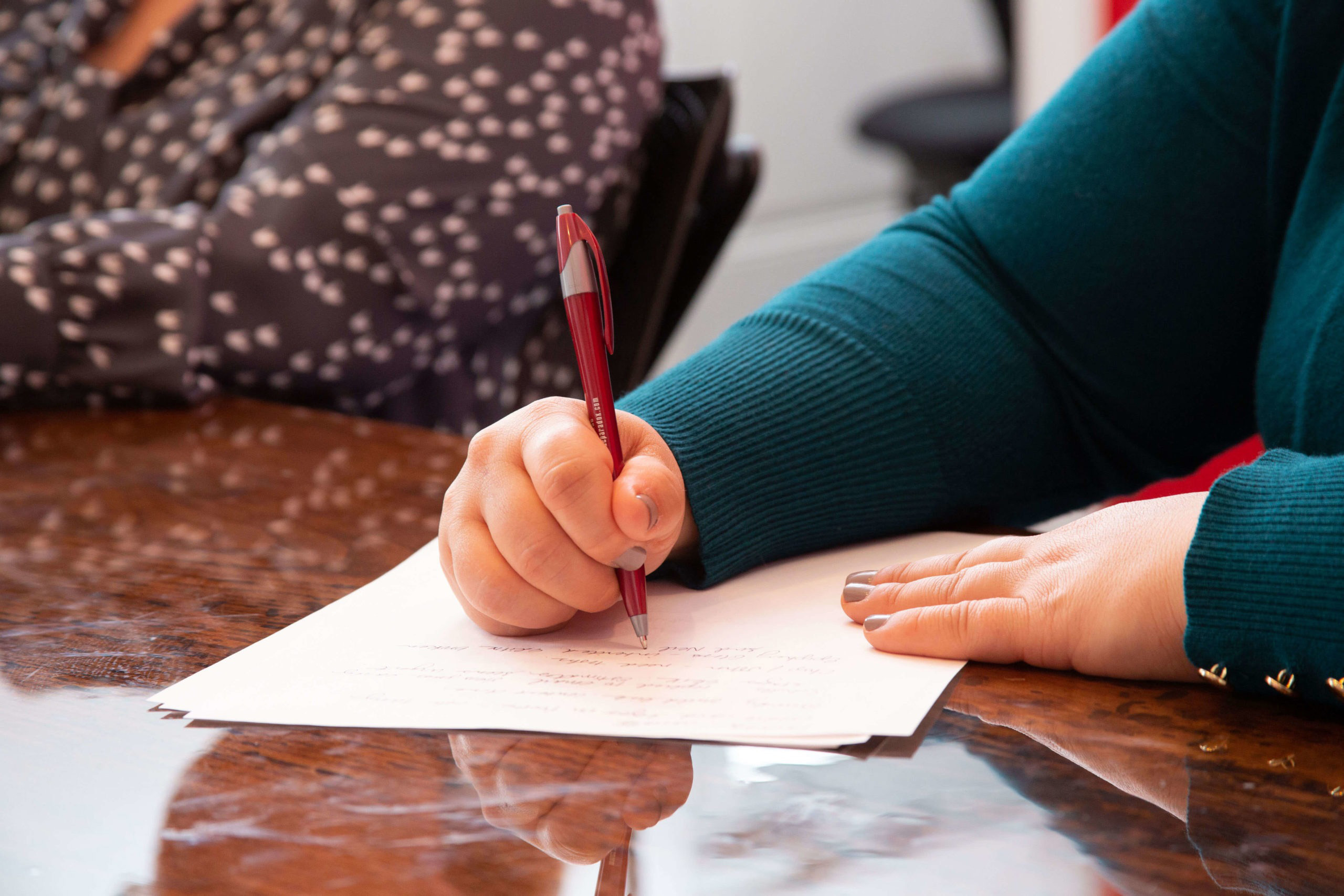 Woman taking notes at conference table