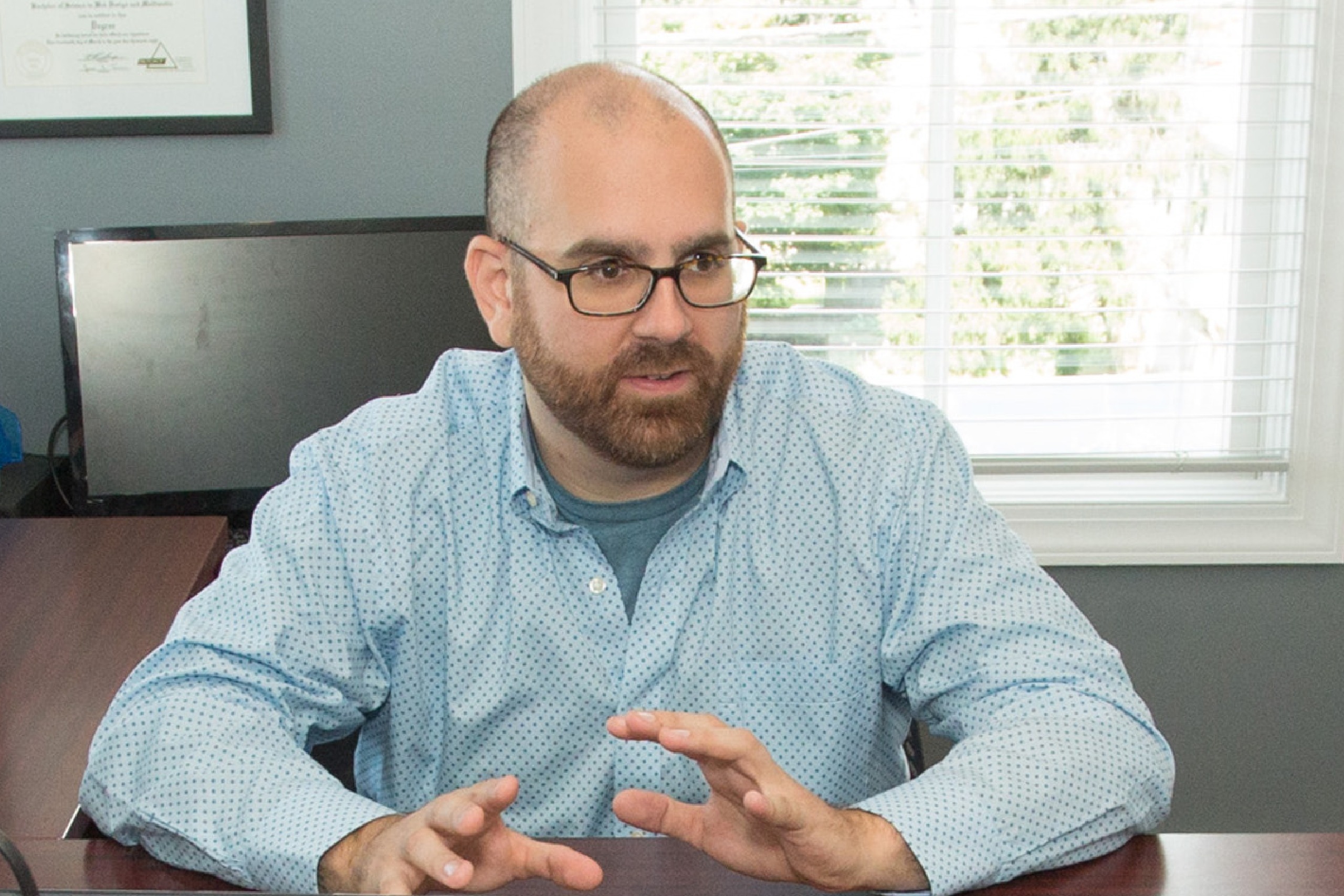 Neil in meeting at his desk